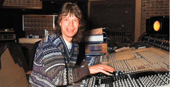 Mick Jagger from The Rolling Stones sits at the mixing desk in Wisseloord Studios,  while working on Primitive Cool (Photo by Rob Verhorst/Redferns)